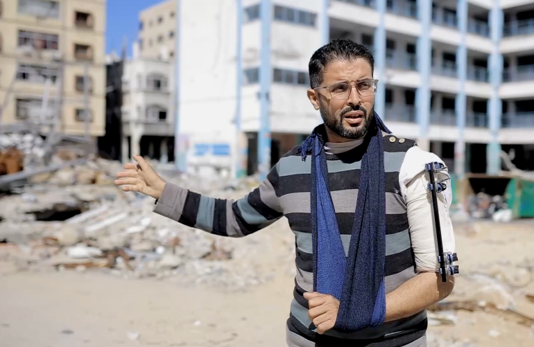 Jaber standing in the ruins, explaining what happened