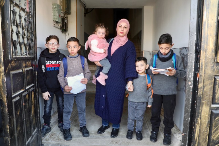 Lina Amro with her children in the entrance of their building