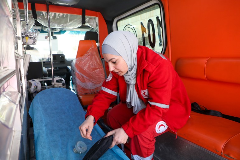 Lina Amro prepares equipment for the day's work in the ambulance