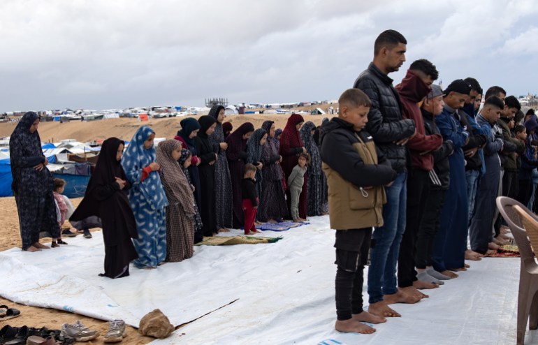 epa11269314 Displaced Palestinians, who escaped the ongoing conflict between Israel and Hamas, perform Eid al-Fitr prayers next to their tents set up near the Egyptian border, at the Rafah camp in the southern Gaza Strip,