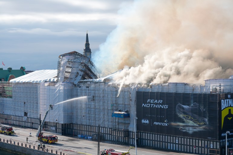epa11281366 Firefighters work to extinguish a fire at the old Stock Exchange (Boersen) in Copenhagen, Denmark, 16 April 2024. A violent fire broke out in the building which is under renovation on the morning of 16 April. The building was erected in the 1620s as a commercial building by King Christian IV and is located next to the Danish parliament. EPA-EFE/Emil Helms DENMARK OUT