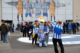 Brighton fans with mascots outside the Amex stadium [Peter Nicholls/Reuters]