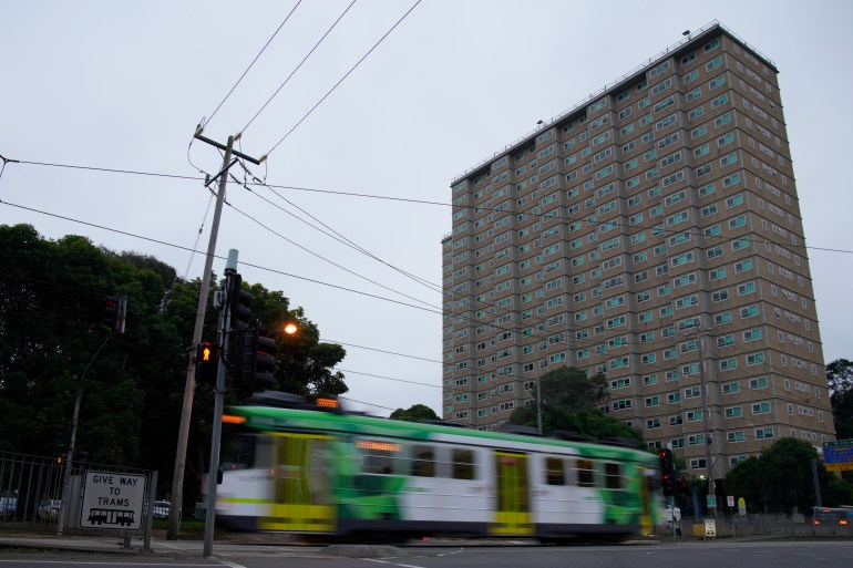 A tram passing a public housing block in Melbourne