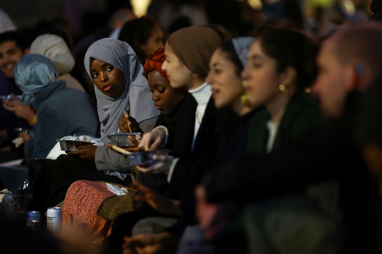 A woman reacts at an open Iftar, during the fasting month of Ramadan, in London, Britain April 13, 2022