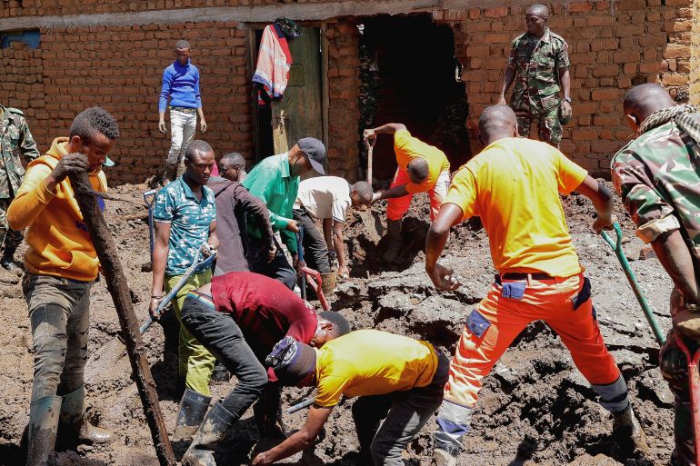 Members of the Tanzania Defense Forces and rescuers search for the bodies of people killed following flash floods and landslides in the Manyara region, December 4, 2023