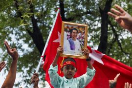 A protester holds up a portrait of Aung San Suu Kyi during a demonstration to mark the third anniversary of the 2021 coup [Chalinee Thirasupa/ Reuters]
