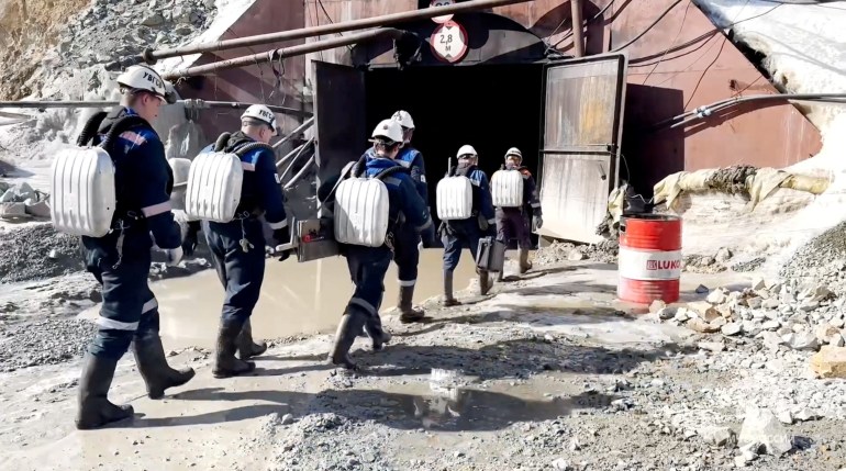 Rescuers take part in a search operation in an attempt to save 13 miners, who were trapped in the Pioneer gold mine after a rock fall, in the Amur region, Russia