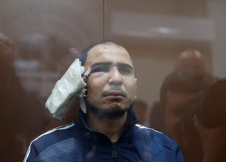 Saidakrami Murodali Rachabalizoda, a suspect in the shooting attack at the Crocus City Hall concert venue, sits behind a glass wall of an enclosure for defendants at the Basmanny district court in Moscow, Russia March 24, 2024. REUTERS/Yulia Morozova