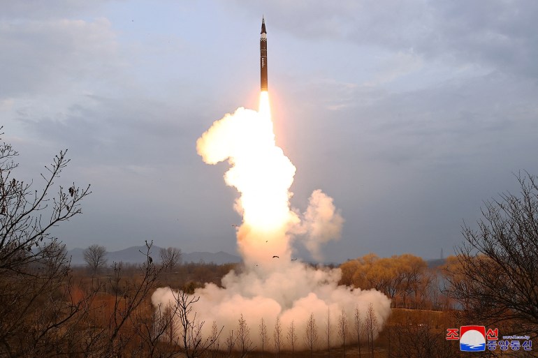 The Hwasong-16B taking off. There is smoke and flame.