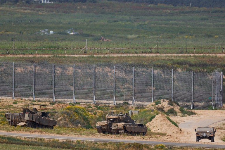 Israeli military vehicles hold position, amid the ongoing conflict between Israel and the Palestinian Islamist group Hamas, near the Israel-Gaza border, as seen from Israel, April 4, 2024. REUTERS/Hannah McKay