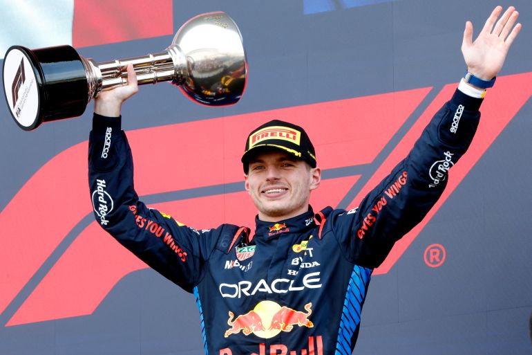 Red Bull's Max Verstappen celebrates with the trophy on the podium at the Japanese GP.