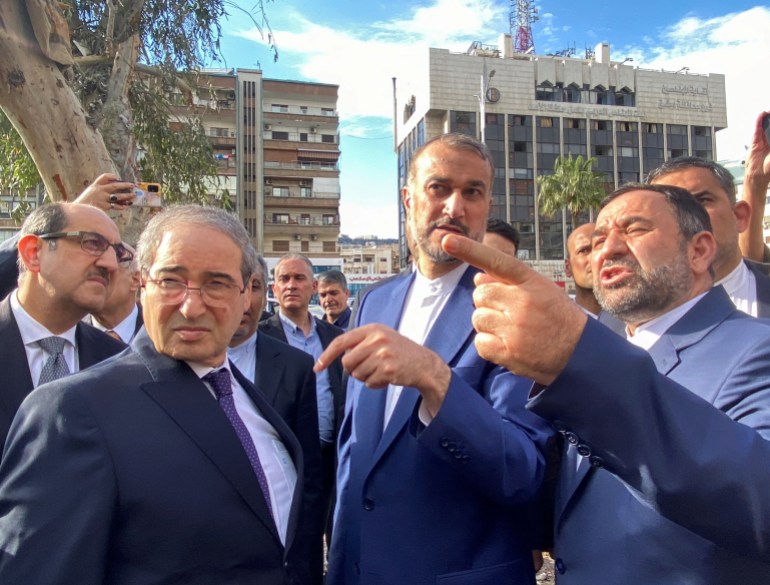 Syrian Foreign Minister Faisal Mekdad, Iran's Foreign Minister Hossein Amirabdollahian and Iran's ambassador in Damascus Hossein Akbari, stand together near Iran's consulate in Damascus that was targeted in a suspected Israeli attack on April 1, in Damascus, Syria April 8