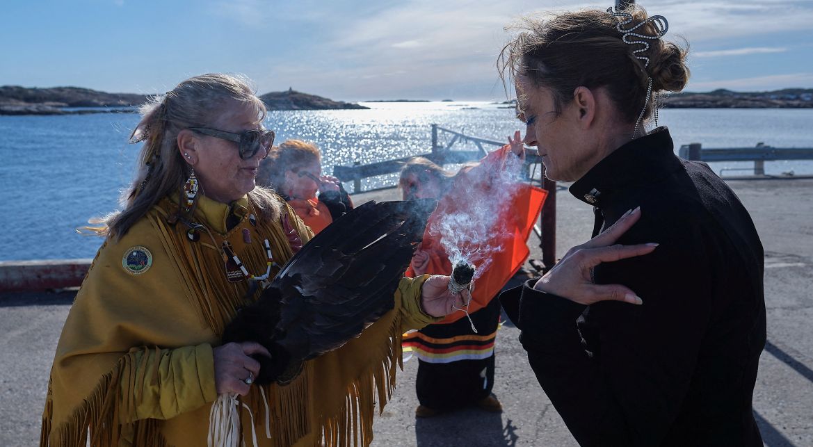 Members of the Burgeo First Nation participate in a smudging ceremony.