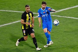 Al Ittihad&#039;s Abderrazak Hamdallah, ina the yellow-and-black jersey, in action with Al Hilal&#039;s Ruben Neves on April 11 2024 in Abu Dhabi, UAE [Rula Rouhana/Reuters]