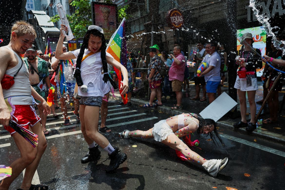 Revellers dance and play with water during a gay parade as they celebrate the Songkran holiday which marks the Thai New Year in Bangkok, Thailand, April 14