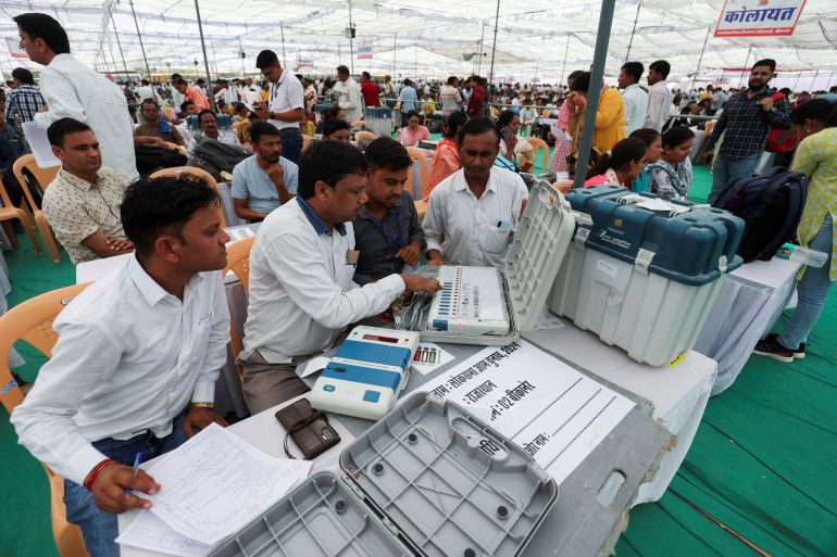 Election staff check the Electronic Voting Machines (EVM) at a polling station, ahead of the first phase of the election, in Bikaner