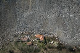 A destroyed house is seen near an open-pit copper mine, run by a subsidiary of China&#039;s Zijin Mining, near the village of Krivelj, Serbia. Krivelj&#039;s landscape is scarred by piles of mining waste, lines of orange trucks snaking up the brown valley and cracked houses from the tremors of the underground explosions. [Marko Djurica/Reuters]