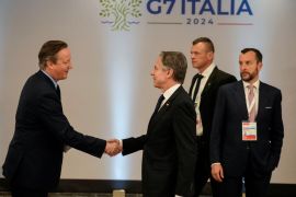 US Secretary of State Antony Blinken, centre, greets British Foreign Secretary David Cameron in Capri, Italy, on April 19, 2024 [Gregorio Borgia/Pool via Reuters]