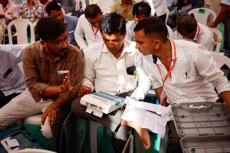 Election officials check the election materials after collecting them at a distribution centre ahead of the second phase of the general elections