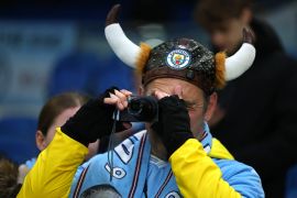 Manchester City fan with a camera inside the stadium before the match [Toby Melville/Reuters] (Reuters)