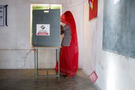 A woman votes at a polling station during the second phase of the general election in Barmer, Rajasthan [Adnan Abidi/Reuters]