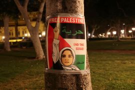 A poster is seen as people protest in support of Palestinians in Gaza at the University of Southern California (USC) [Aude Guerrucci/Reuters]