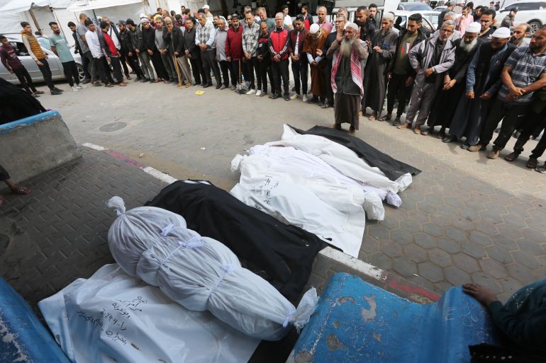 Dead bodies of Palestinians killed in the Israeli attacks on the house belonging to the Abu Gula family at Nuseirat refugee camp, are taken from the morgue of al-Aqsa Martyrs Hospital for burial in Deir Al-Balah, Gaza on April 10