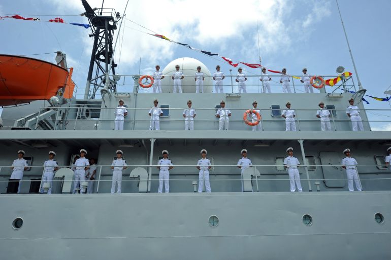 Crew members of the Chinese Navy stand guard on the deck of Chinese PLA Navy ship Zheng He
