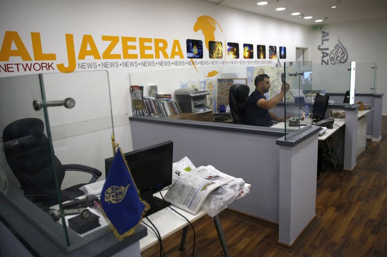 An employee of the Qatar based news network and TV channel Al-Jazeera is seen at the channel's Jerusalem office