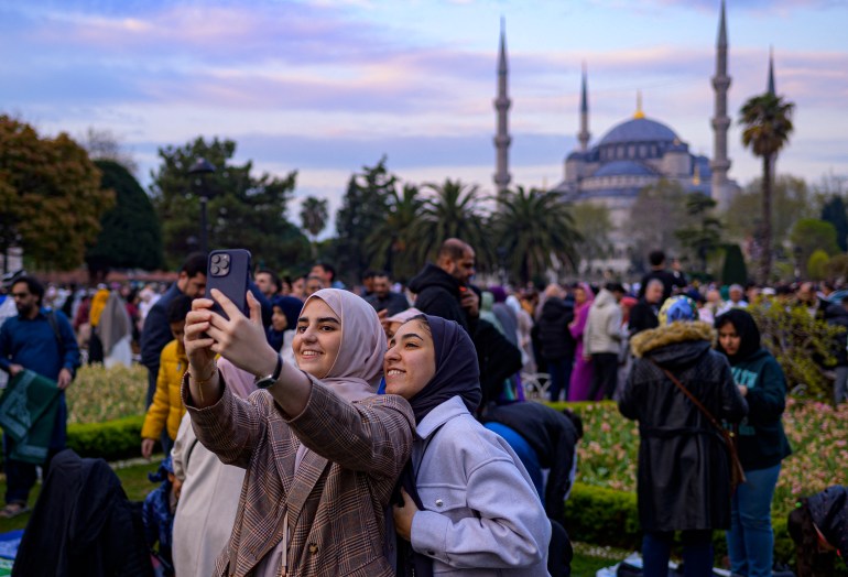 Muslim worshippers prepare to take part in a morning prayer on the first day of Eid al-Fitr, which marks the end of the holy fasting month of Ramadan, at the Blue Mosque in Istanbul, on April 21, 2023 [Yasin Akgul /AFP]