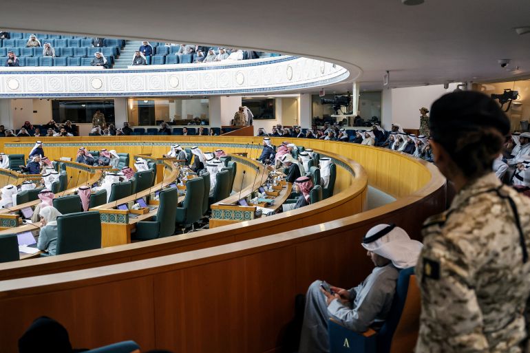 Female security guards stand by as Kuwaiti lawmakers attend a parliament session at the National Assembly in Kuwait City