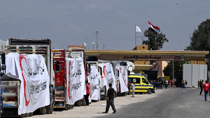 Egyptian Red Crescent trucks loaded with aid queue outside the Rafah border crossing