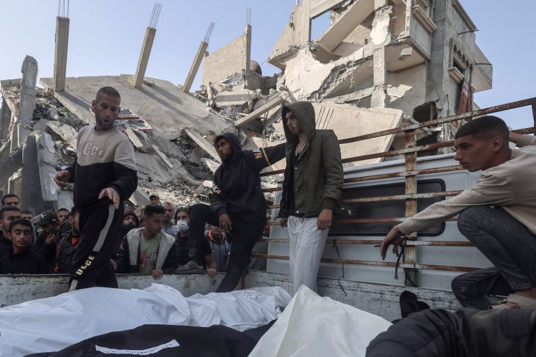 Palestinians gather around the bodies of victims before they are taken away on April 2, 2024 following Israeli bombardment of a residential neighbnourhood in Rafah in the southern Gaza Strip, amid the ongoing conflict between Israel and Hamas. (Photo by MOHAMMED ABED / AFP)