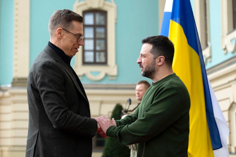 Finnish President Alexander Stubb met Ukrainian President Volodymyr Zelenskyy in Kiev.  Zelensky welcomed her and shook hands.  A Ukrainian flag is behind them.