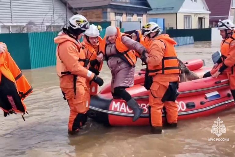 This photo taken from a video released by the Russian Emergency Situations Ministry on April 6, 2024 shows rescuers evacuate a resident
