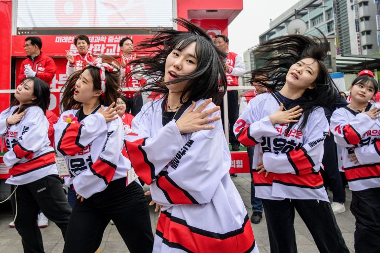 Campaigners for the People Power Party putting on a dance display during a campaign rally. The group of young women is dressed in the party's colours