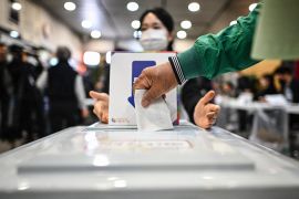 A voter casts their ballot in Seoul early on Wednesday [Anthony Wallace/AFP]