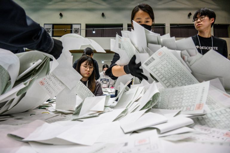 Korean election officials sorting ballot papers