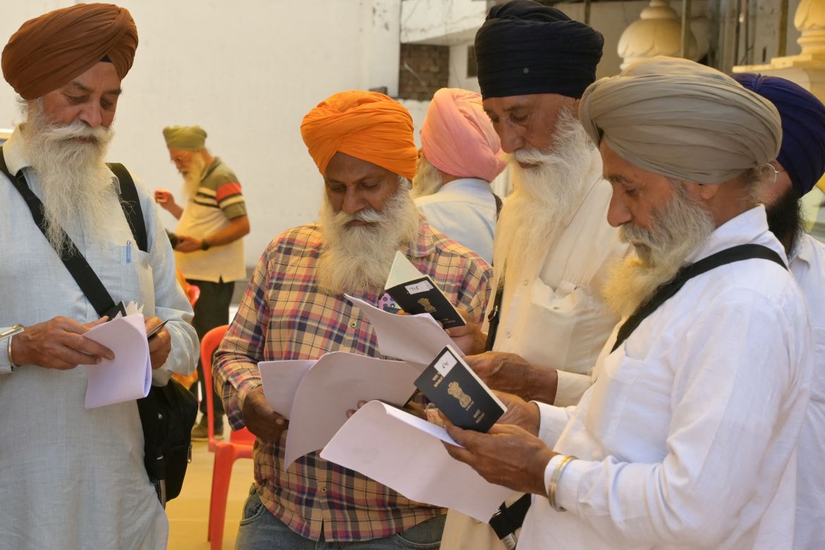 Sikh pilgrims check their passports at the Golden Temple in Amritsar on April 12