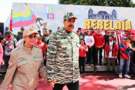 Venezuelan President Nicolas Maduro (C) and First Lady Cilia Flores arrive at a political rally in Caracas, on April 13, 2024 [Zurimac Campos/Venezuelan Presidency via AFP]