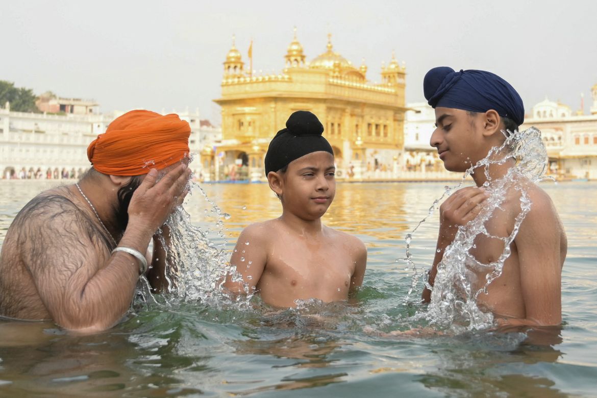 Sikh devotees bath in the holy sarovar (water tank) on the occasion of 'Baisakhi', a spring harvest festival, at the Golden Temple in Amritsar on April 13
