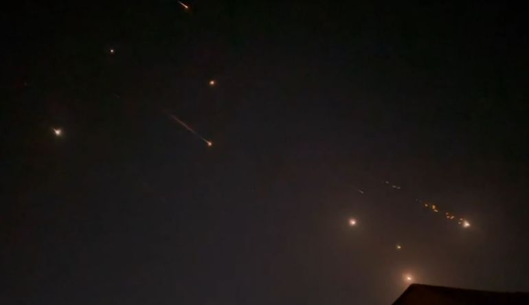 This video grab from AFPTV taken on April 14, 2024 shows explosions lighting up the sky in Hebron, Palestinian Territories, during an Iranian attack on Israel.