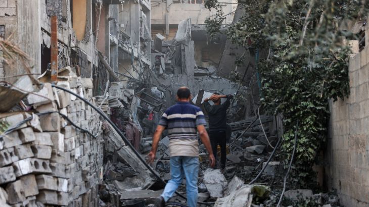 Palestinians check the rubble of a building after Israeli bombardment at Al-Daraj neighbourhood