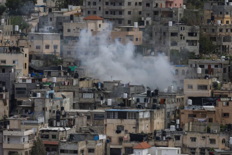 Smoke rises among buildings in the Nur Shams refugee camp in the occupied West Bank, during an Israeli army raid on April 19, 2024. (Photo by JAAFAR ASHTIYEH / AFP)