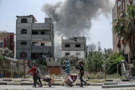 Smoke billows after an Israeli attack on a building in the Bureij camp in central Gaza on Monday [AFP]