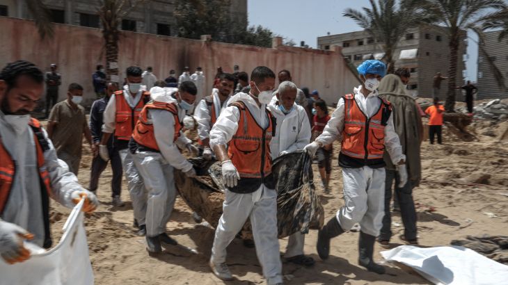 People and health workers unearth bodies found at Nasser Hospital in Khan Yunis in the southern Gaza Strip