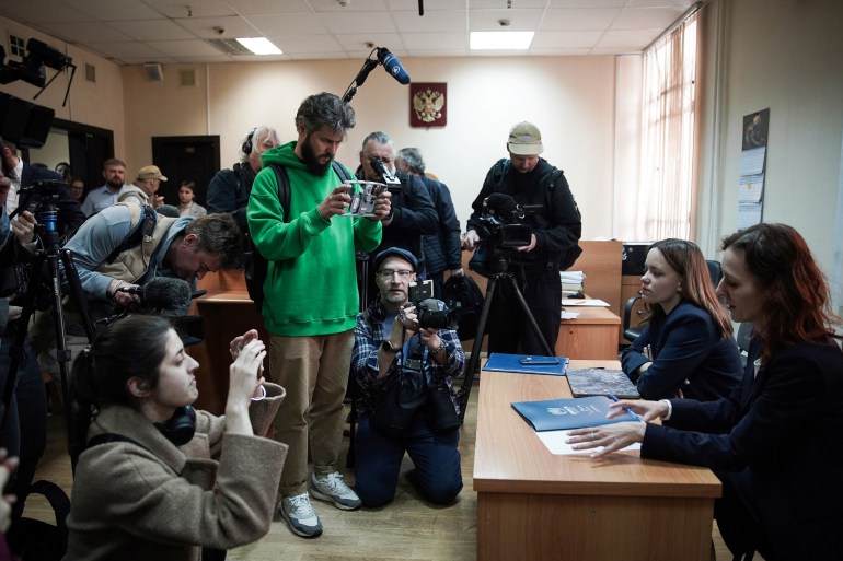 Alexandra Bayeva (L) and Katerina Tertukhina, lawyers of Oleg Orlov speak to the press. They are seated at a table. The media are in front of them.