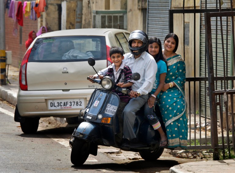 In this March 3, 2010 photo, Pronob Biswas and his family ride on his Bajaj Scooter, in New Delhi, India. Once there was the waiting list to buy Bajaj scooters, a wait which often lasted for years. There was the pride of that first ride and you knew that you'd finally made it to the middle class. Later this month, Bajaj's last scooter will roll out from its factory, ending an era in India's transition from dreary socialist economy into a consumerist power house.(AP Photo/Manish Swarup)