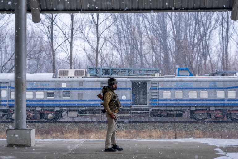 A paramilitary soldier stands guard inside a railway station before the flagging off of the first electric train in the Kashmir valley on the outskirts of Srinagar, Indian controlled Kashmir, Tuesday, Feb. 20, 2024. Prime Minister Narendra Modi on Tuesday virtually flagged off the train service between Sangaldan station and Baramulla station during a public rally in Jammu. (AP Photo/Dar Yasin)