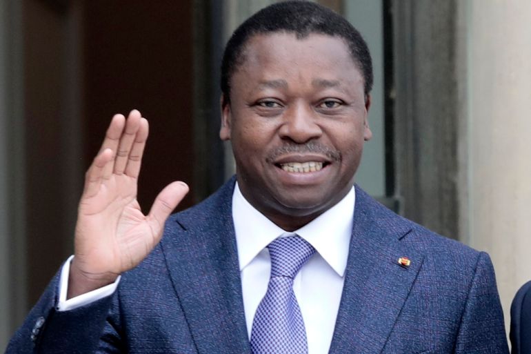 Togo's President Faure Gnassingbe waves before a working lunch at the Elysee Palace in Paris